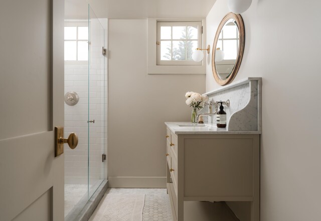 bathroom featuring a shower stall, vanity, and plenty of natural light