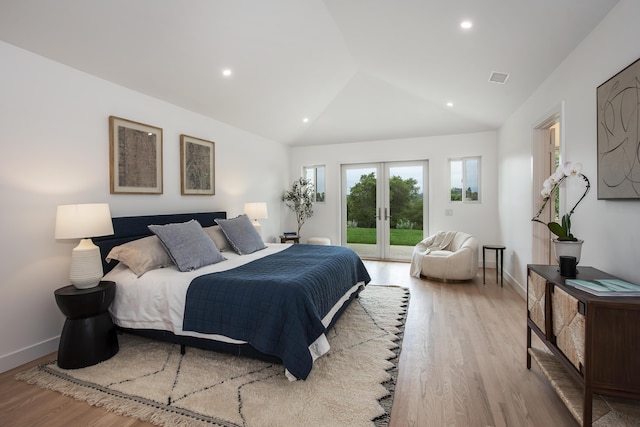 bedroom with french doors, vaulted ceiling, visible vents, wood finished floors, and access to outside