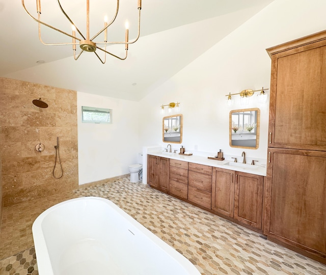 full bathroom featuring a freestanding bath, toilet, a sink, and tiled shower