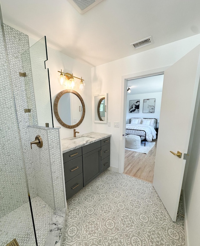 full bathroom featuring walk in shower, visible vents, vanity, and connected bathroom