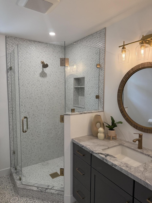 bathroom featuring visible vents, tile patterned floors, vanity, and a stall shower