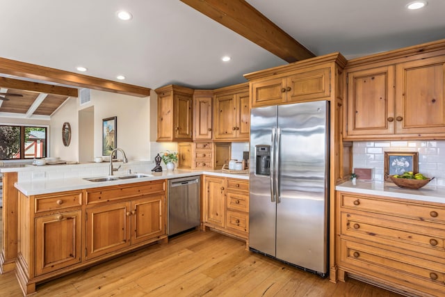 2760 Williams Way, Santa Barbara, CA 93105 - kitchen featuring appliances with stainless steel finishes, a sink, light countertops, a peninsula, and decorative backsplash