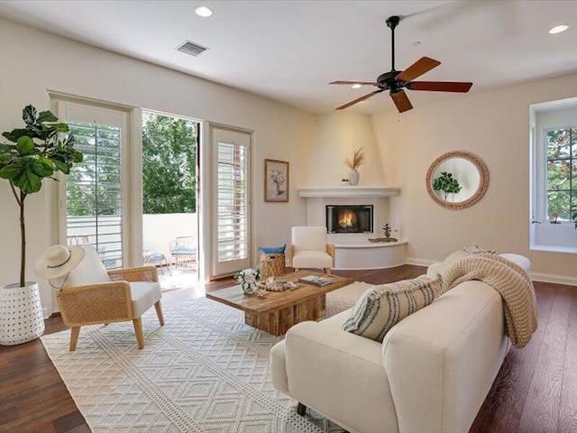 living room with visible vents, recessed lighting, wood finished floors, ceiling fan, and a fireplace