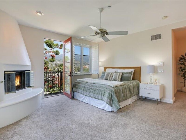 bedroom with ceiling fan, light carpet, access to outside, and visible vents