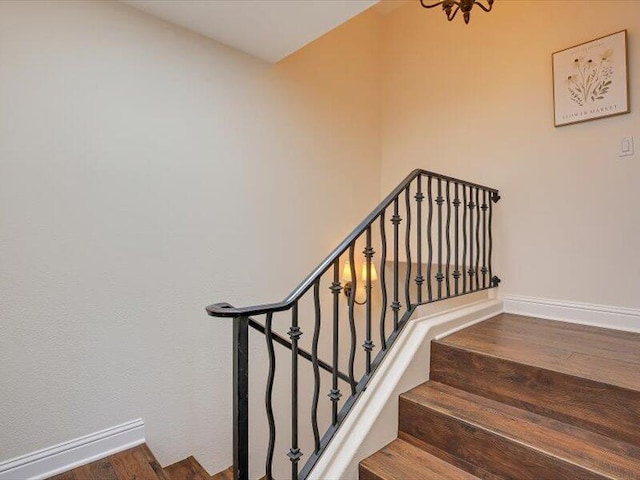 stairs with baseboards and wood finished floors