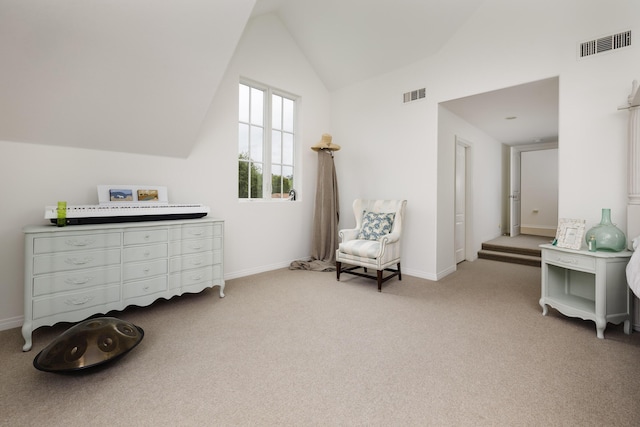 living area featuring lofted ceiling, baseboards, visible vents, and carpet
