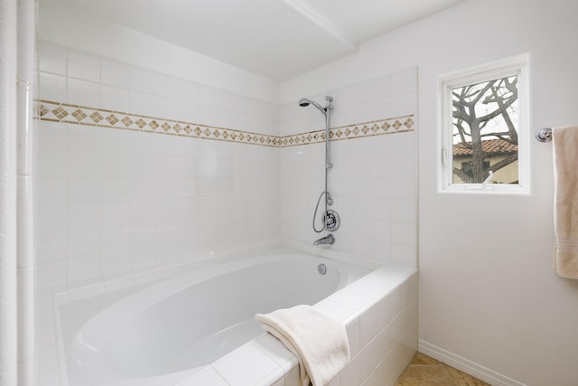 full bathroom with baseboards and tiled shower / bath