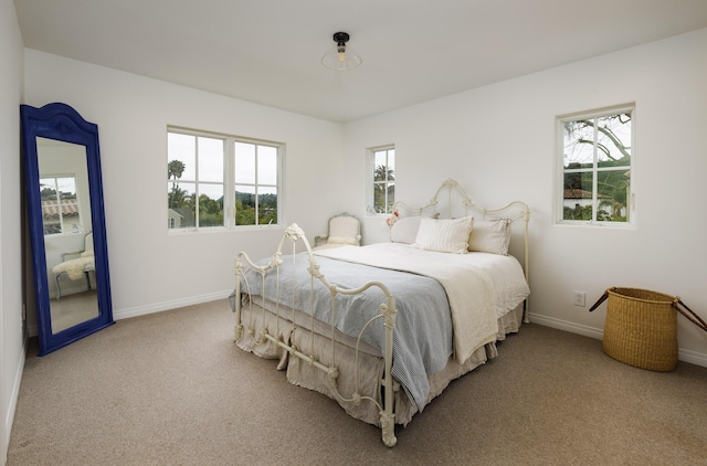 carpeted bedroom with baseboards