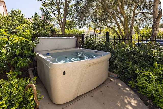 exterior details with fence and a hot tub