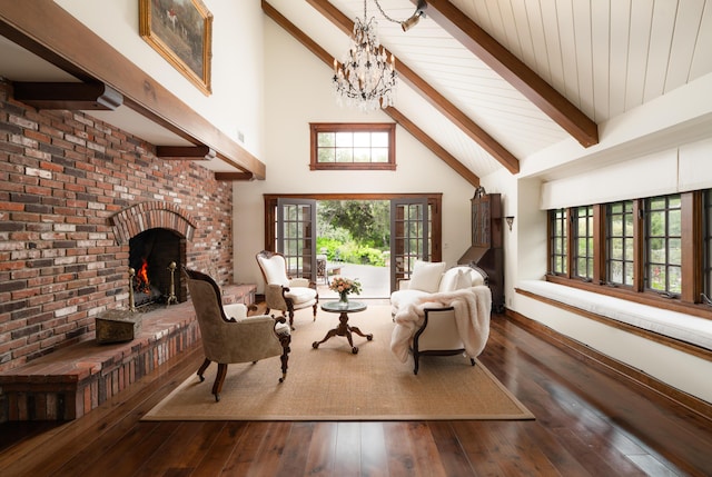 sitting room with a wealth of natural light, beam ceiling, a notable chandelier, hardwood / wood-style flooring, and high vaulted ceiling