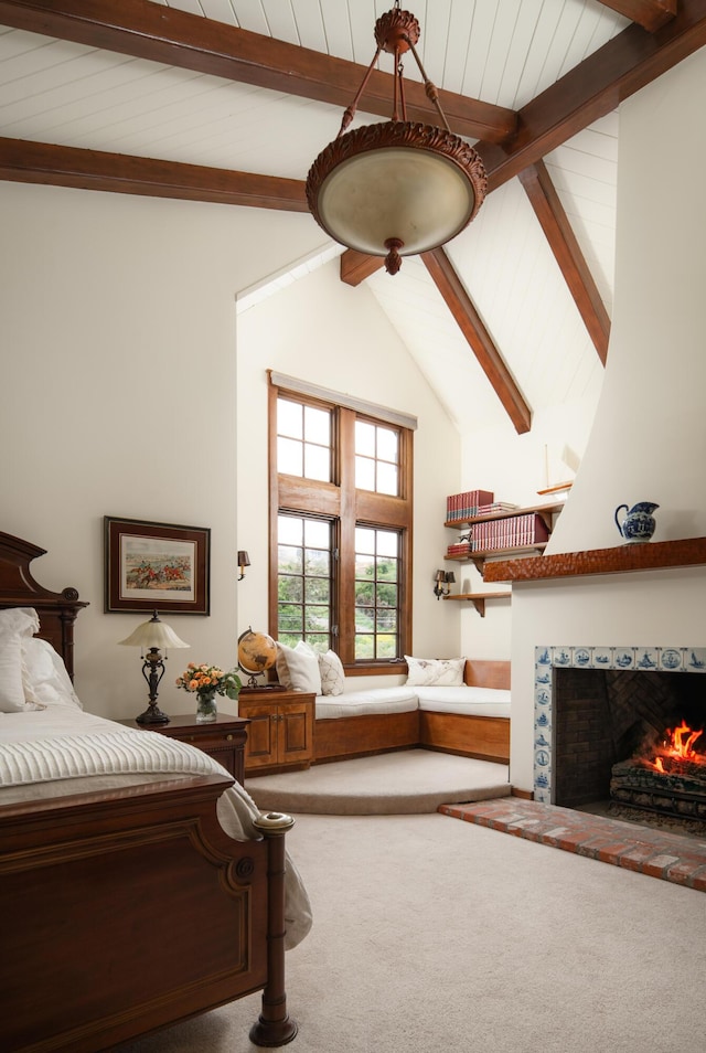 bedroom with beamed ceiling, a fireplace, carpet flooring, and high vaulted ceiling