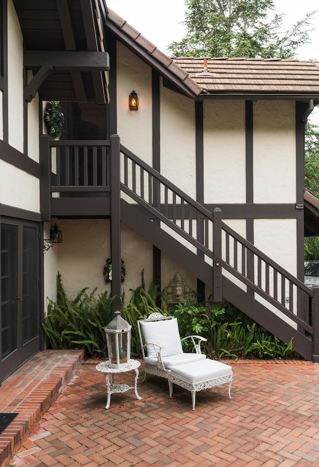 view of patio featuring french doors and stairway