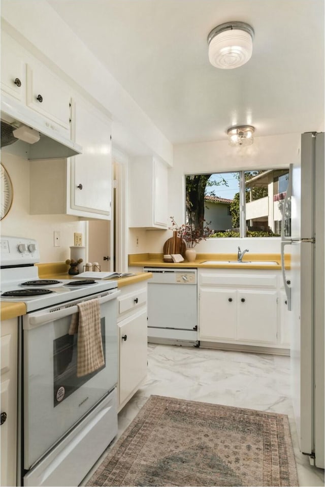 kitchen with under cabinet range hood, marble finish floor, white cabinetry, and white appliances