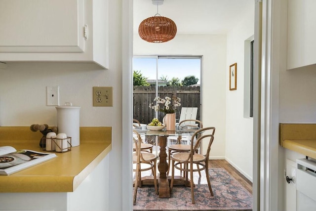 dining room featuring baseboards and wood finished floors