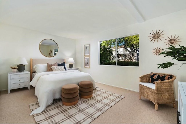 carpeted bedroom with beamed ceiling and baseboards