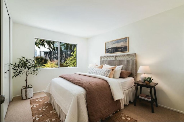 carpeted bedroom featuring baseboards