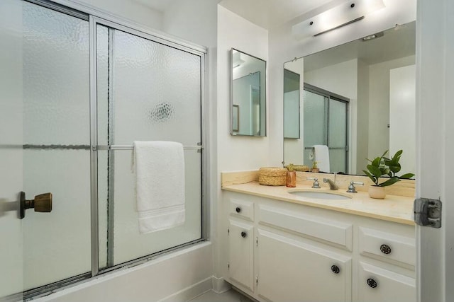 bathroom with an enclosed shower and vanity