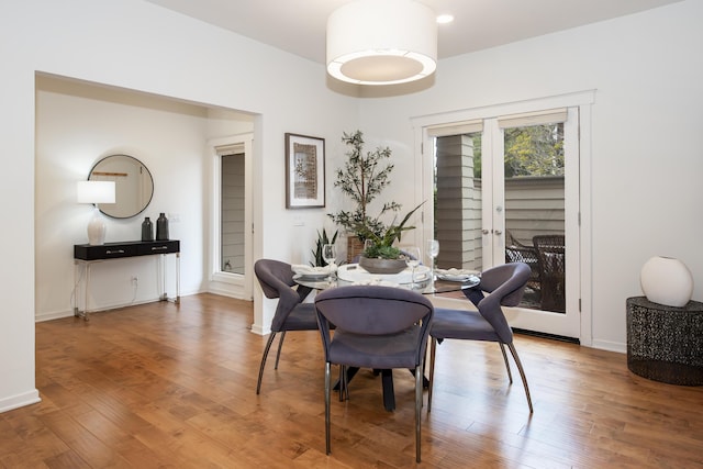 dining space featuring wood finished floors and baseboards