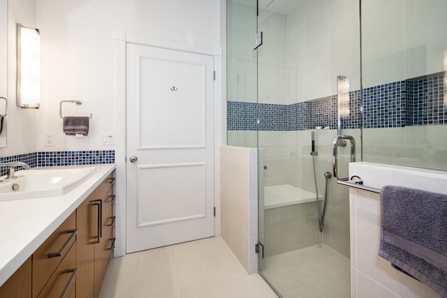 full bathroom featuring tile patterned floors, a shower stall, and vanity