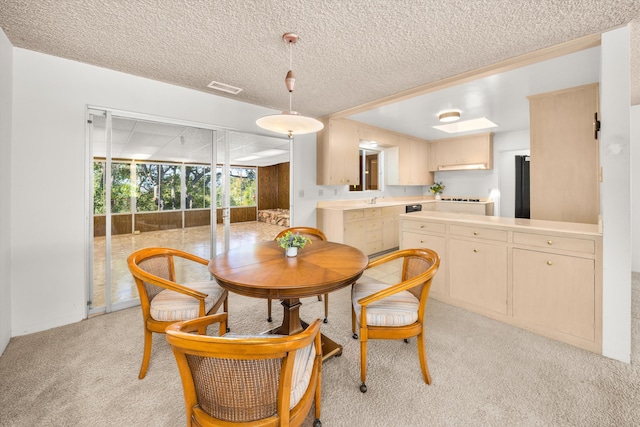 dining space with visible vents, a textured ceiling, and light colored carpet
