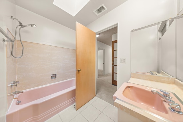 bathroom with a sink, tile patterned flooring,  shower combination, a skylight, and visible vents