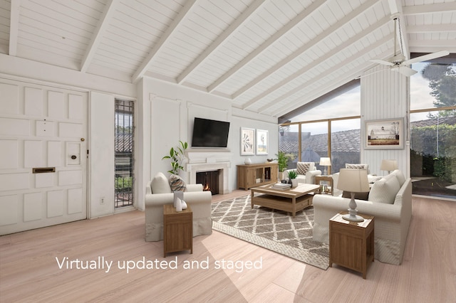living room with a lit fireplace, high vaulted ceiling, beam ceiling, and wood finished floors