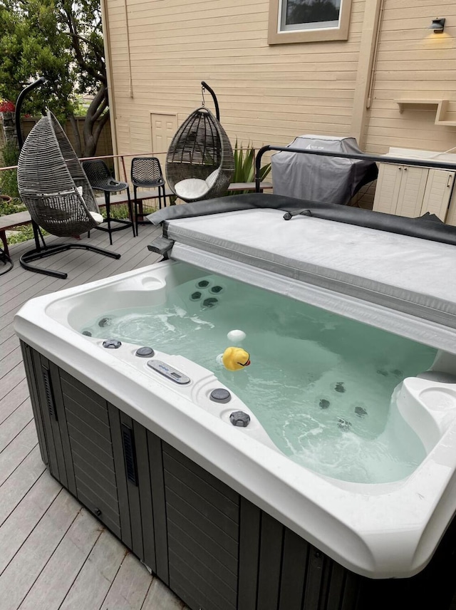 wooden deck with a hot tub