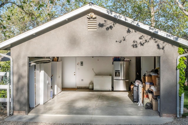back of house featuring stucco siding, a patio, and a garage