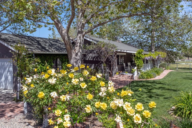 exterior space with fence and a lawn