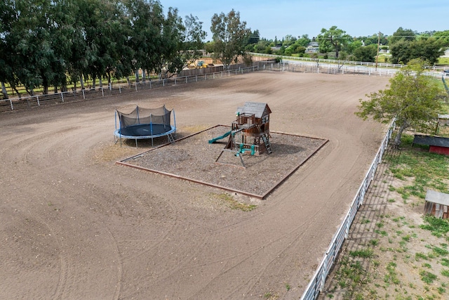 surrounding community featuring a trampoline, a playground, and fence