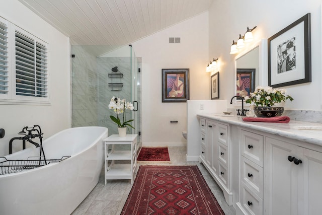 bathroom with lofted ceiling, a shower stall, a soaking tub, a sink, and double vanity
