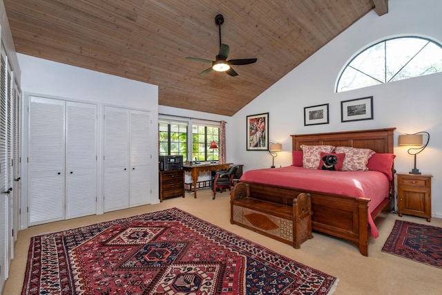 carpeted bedroom featuring ceiling fan, high vaulted ceiling, and wooden ceiling