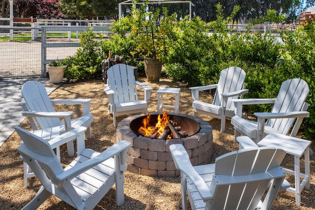 view of patio / terrace with a fire pit and fence