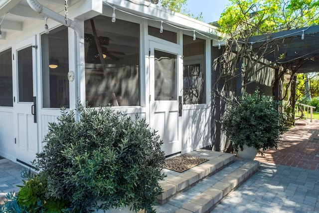 view of home's exterior with a sunroom