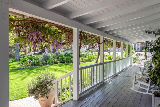 deck with a porch and a lawn