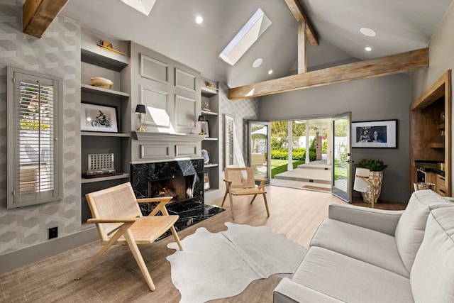 living room with a fireplace, light wood-style floors, recessed lighting, and vaulted ceiling with skylight