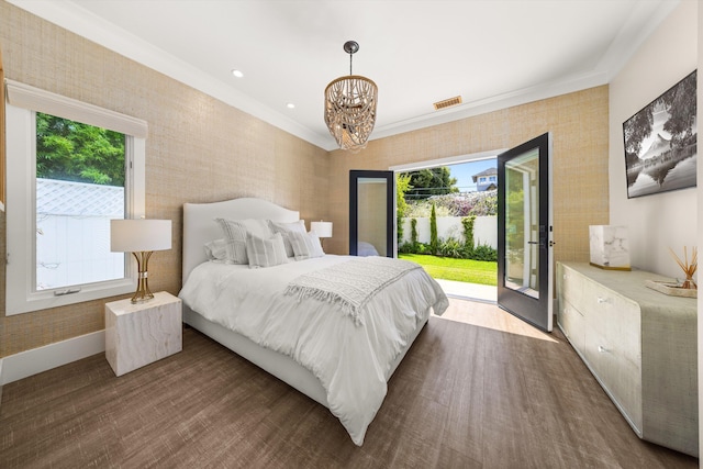 bedroom with a chandelier, visible vents, access to exterior, and multiple windows