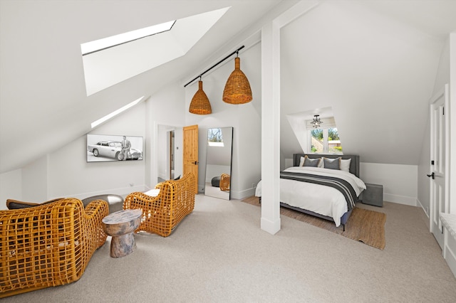 bedroom with baseboards, high vaulted ceiling, a skylight, and carpet