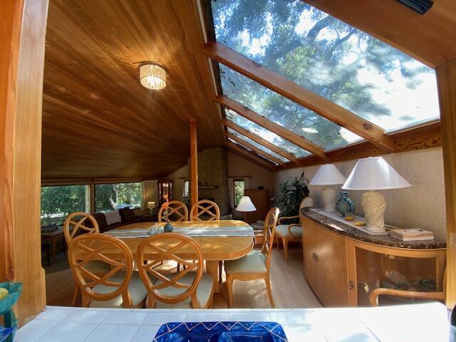 1040 Mission Canyon Rd, Santa Barbara, CA 93105 - dining room with lofted ceiling, a skylight, wood finished floors, and wood ceiling