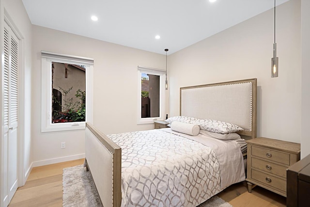 bedroom featuring recessed lighting, light wood finished floors, and baseboards