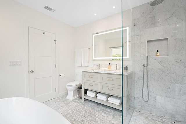 bathroom with vanity, toilet, a marble finish shower, a freestanding tub, and visible vents