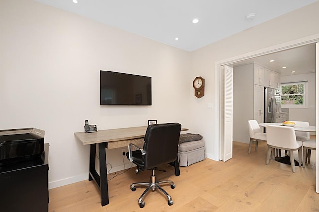 office space featuring recessed lighting, baseboards, and light wood finished floors