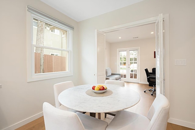 dining space featuring baseboards, french doors, recessed lighting, and wood finished floors
