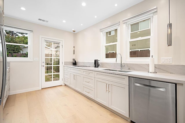 bar featuring visible vents, stainless steel dishwasher, a sink, light wood-style floors, and recessed lighting