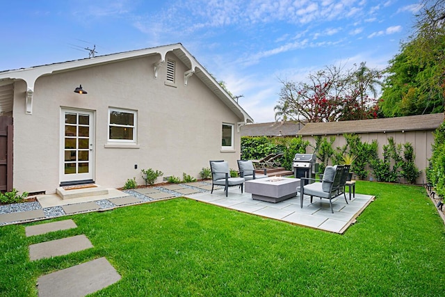 back of property featuring a patio area, stucco siding, a yard, and an outdoor hangout area