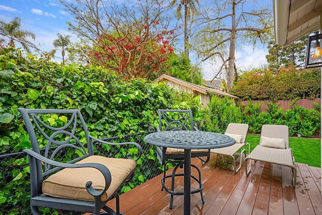 wooden terrace featuring fence