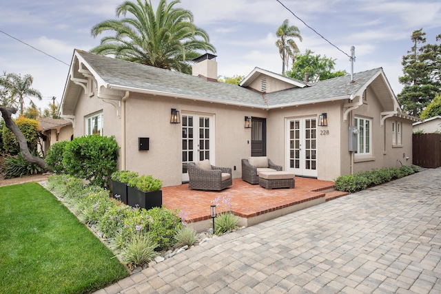 228 W Mission St, Santa Barbara, CA 93101 - rear view of house featuring french doors, a patio area, stucco siding, and a chimney