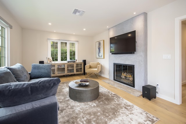 228 W Mission St, Santa Barbara, CA 93101 - living room featuring wood finished floors, healthy amount of natural light, a large fireplace, and recessed lighting