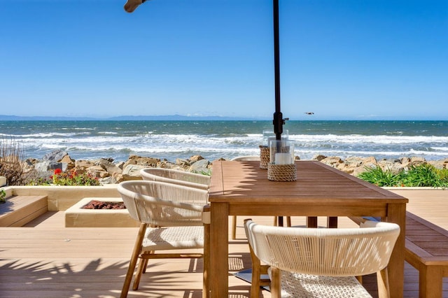 exterior space with a water view and a view of the beach