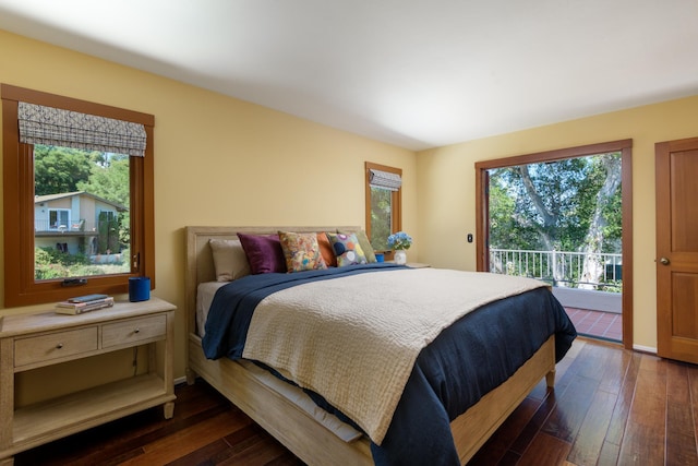 bedroom featuring access to outside, dark wood-style flooring, and baseboards